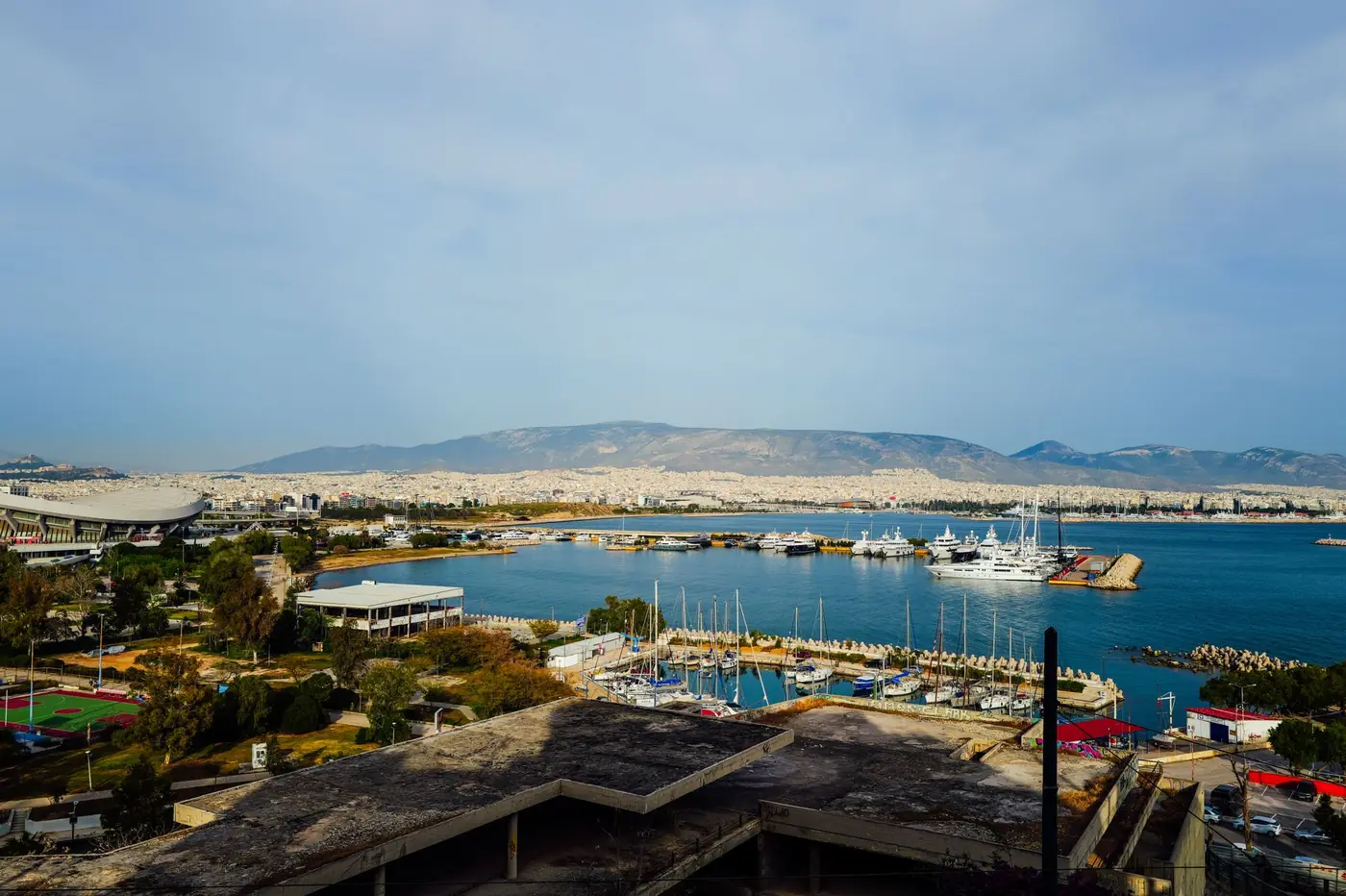 A marina on the Greek coast with the mountains behind