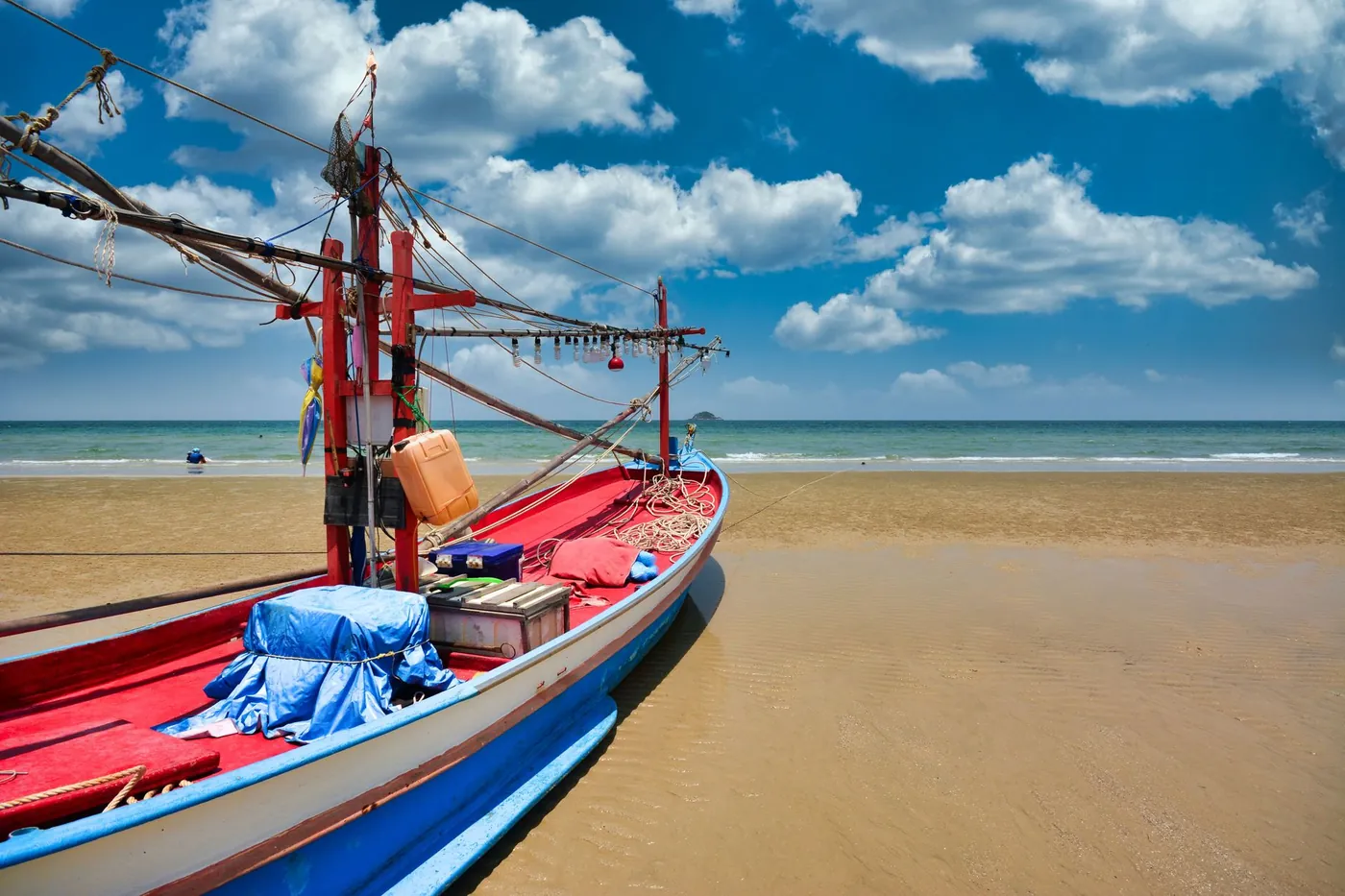 A longtail fishing boat drawn up on a Thai beach
