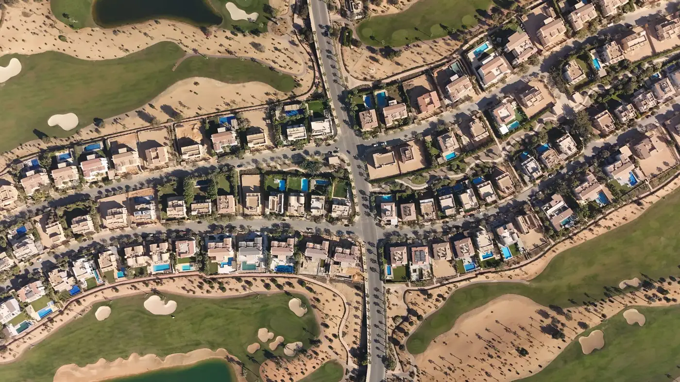 Villas along landscaped streets between golf fairways