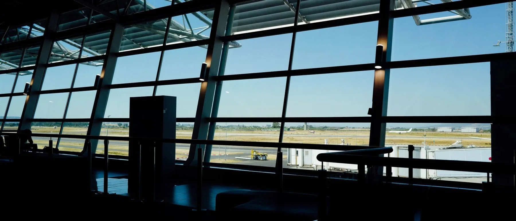 View through an airport terminal window towards the apron