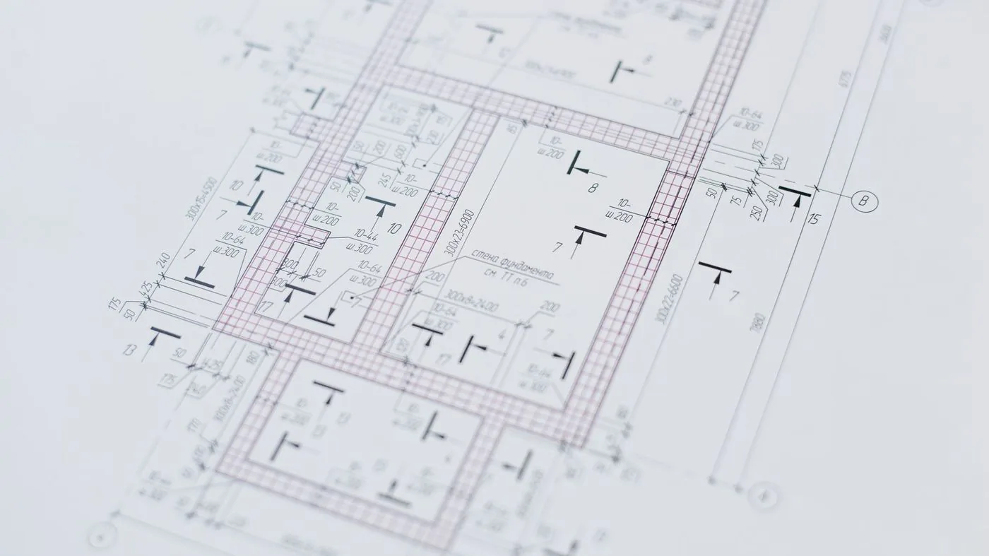 Architectural drawings and a building model on a desk