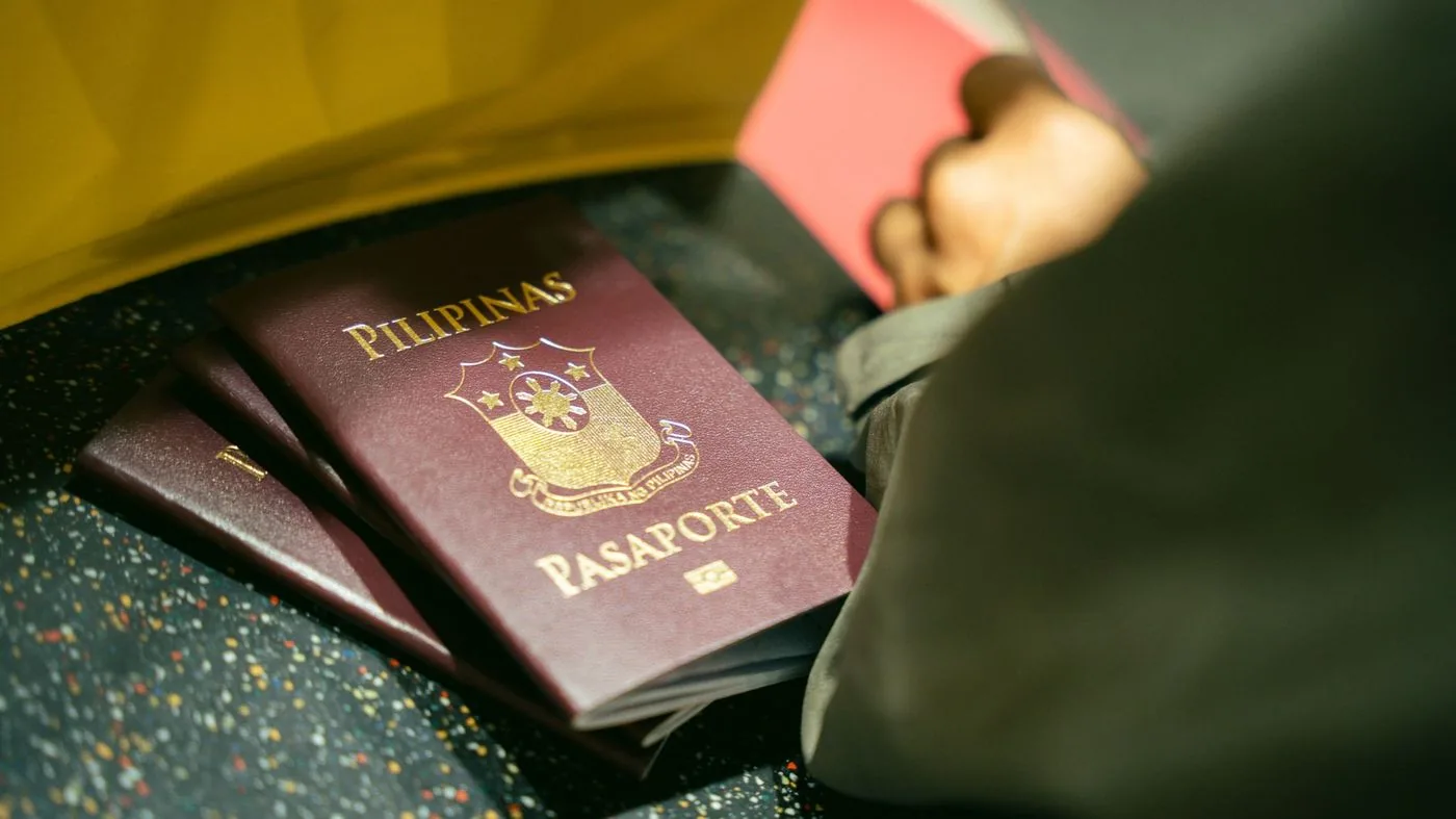 Passport and paperwork laid out on a desk during a visa application