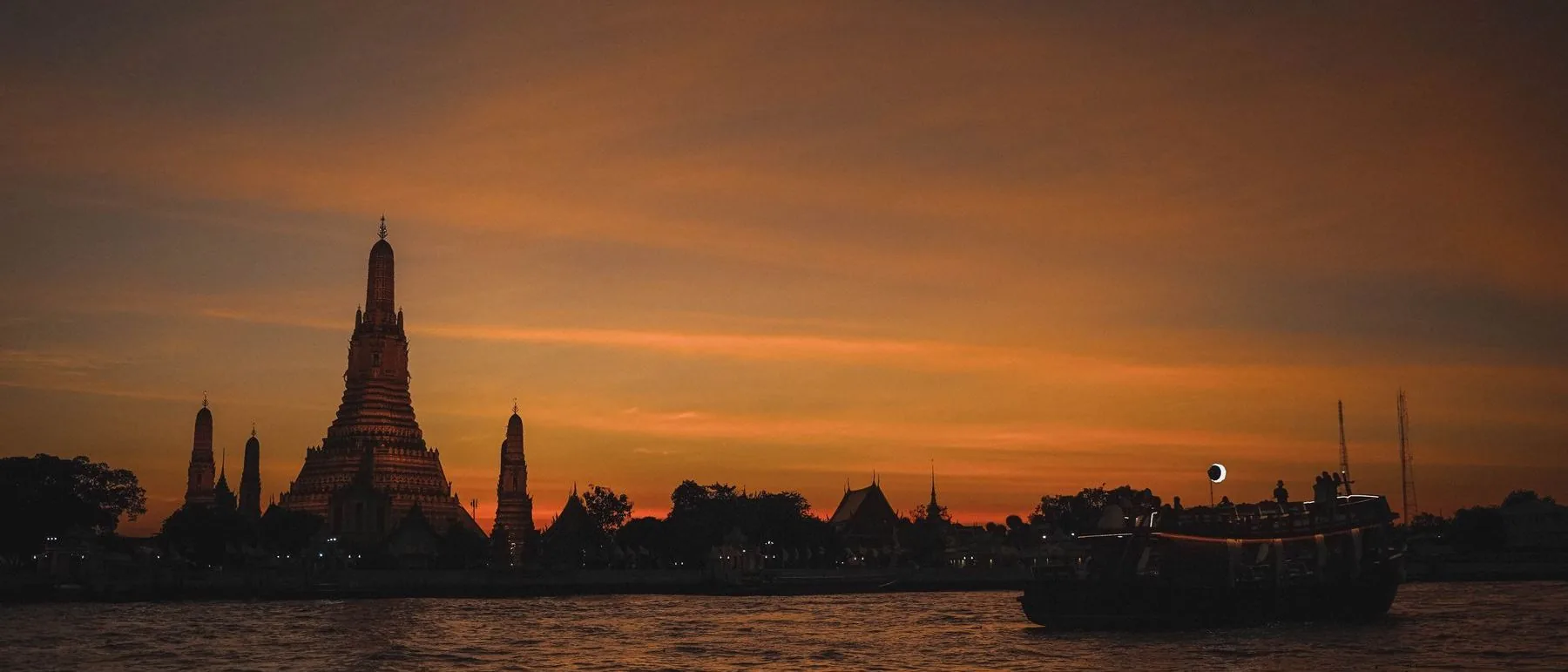 Bangkok skyline at dusk along the Chao Phraya river