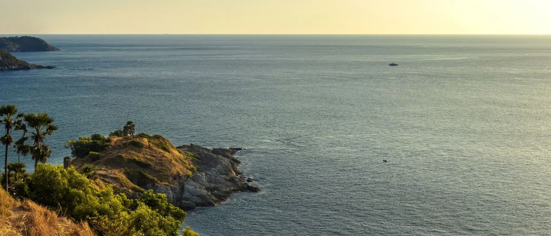 Aerial view of the Phuket coastline with beaches and forested headlands