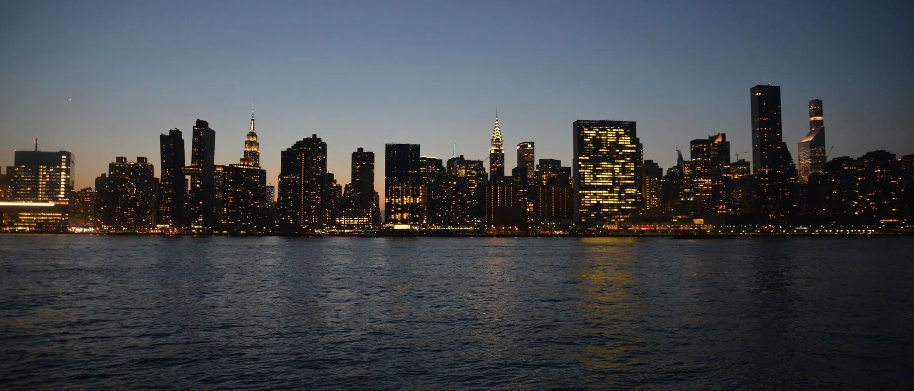 New York skyline at dusk seen across the water