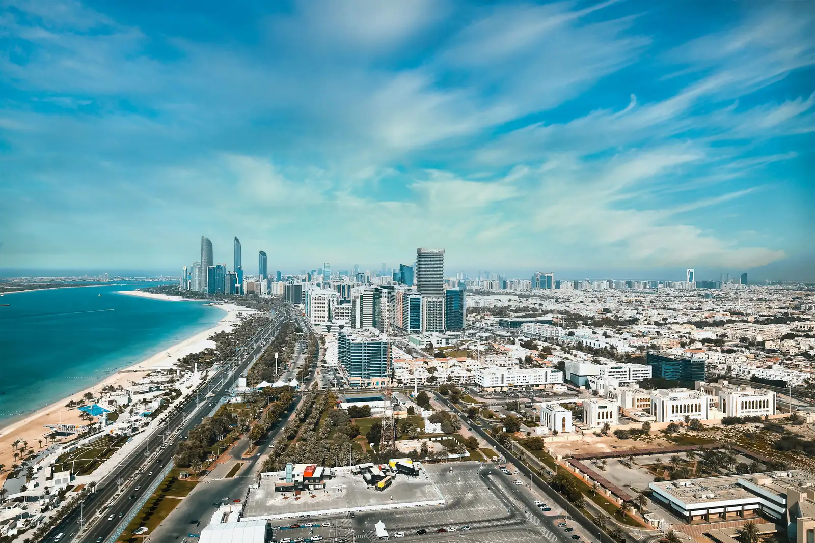 The Abu Dhabi corniche from above, the beach along one side and the towers behind