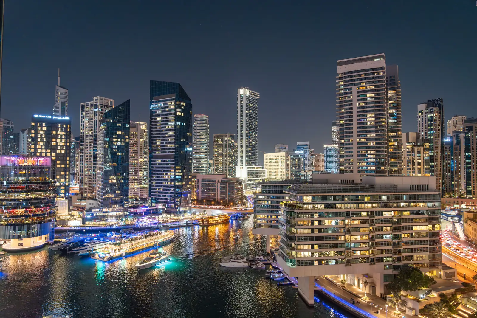 Dubai Marina after dark, the promenade and the moored cruise boats lit up